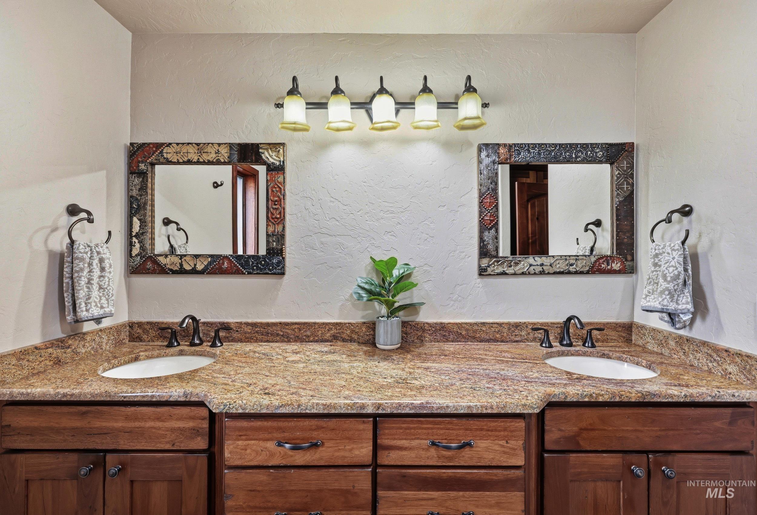 339 Airport Road Weiser, ID 83672 - Photo 17 of 49 Dual vanity with wood cabinetry, granite-finish countertops, and under-mount sinks
