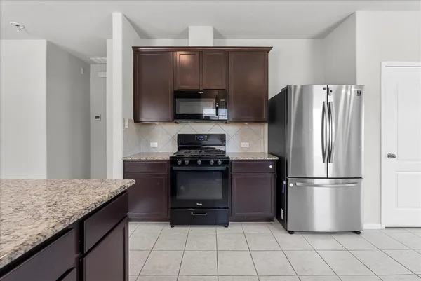 a kitchen with a refrigerator and a sink