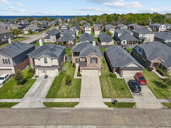 an aerial view of residential houses with outdoor space