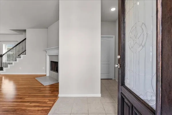 a view of entryway and hall with wooden floor