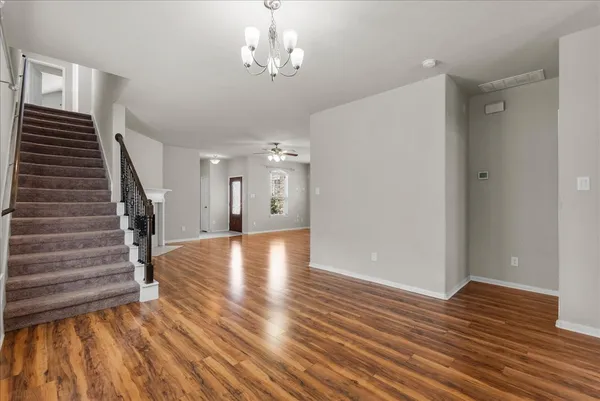 a view of a room with wooden floor and staircase