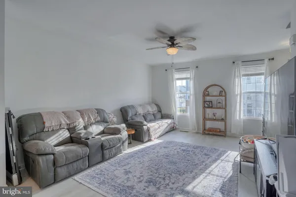 a living room with furniture a couch and dresser