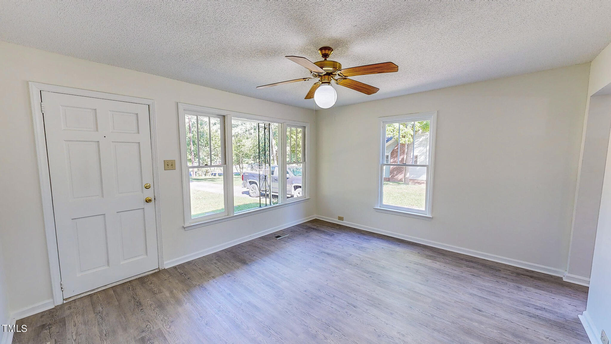 3906 Cole Mill Road Durham, NC 27712 - Photo 15 of 33 a view of an empty room with wooden floor and a window