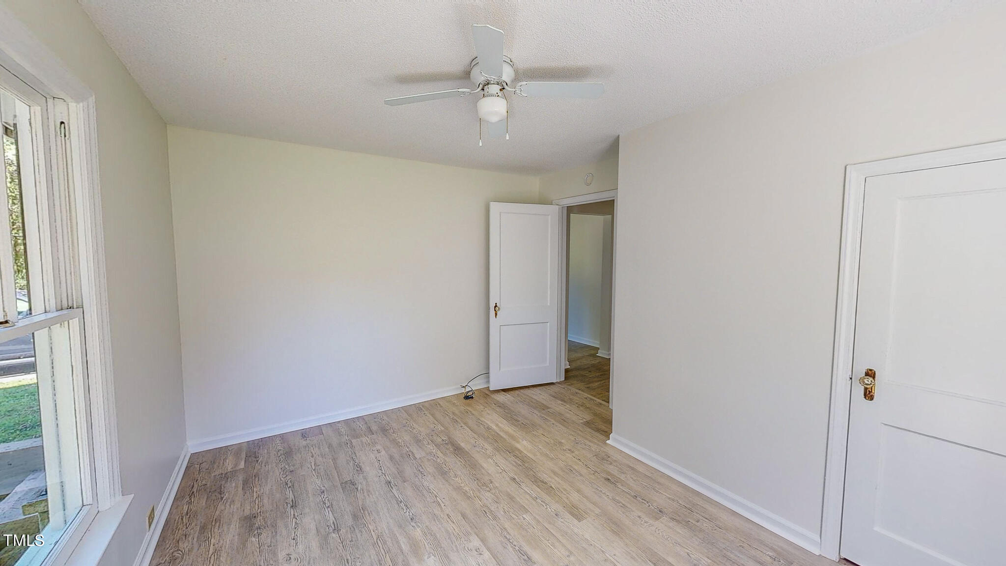 3906 Cole Mill Road Durham, NC 27712 - Photo 18 of 33 a view of an empty room with wooden floor and a window