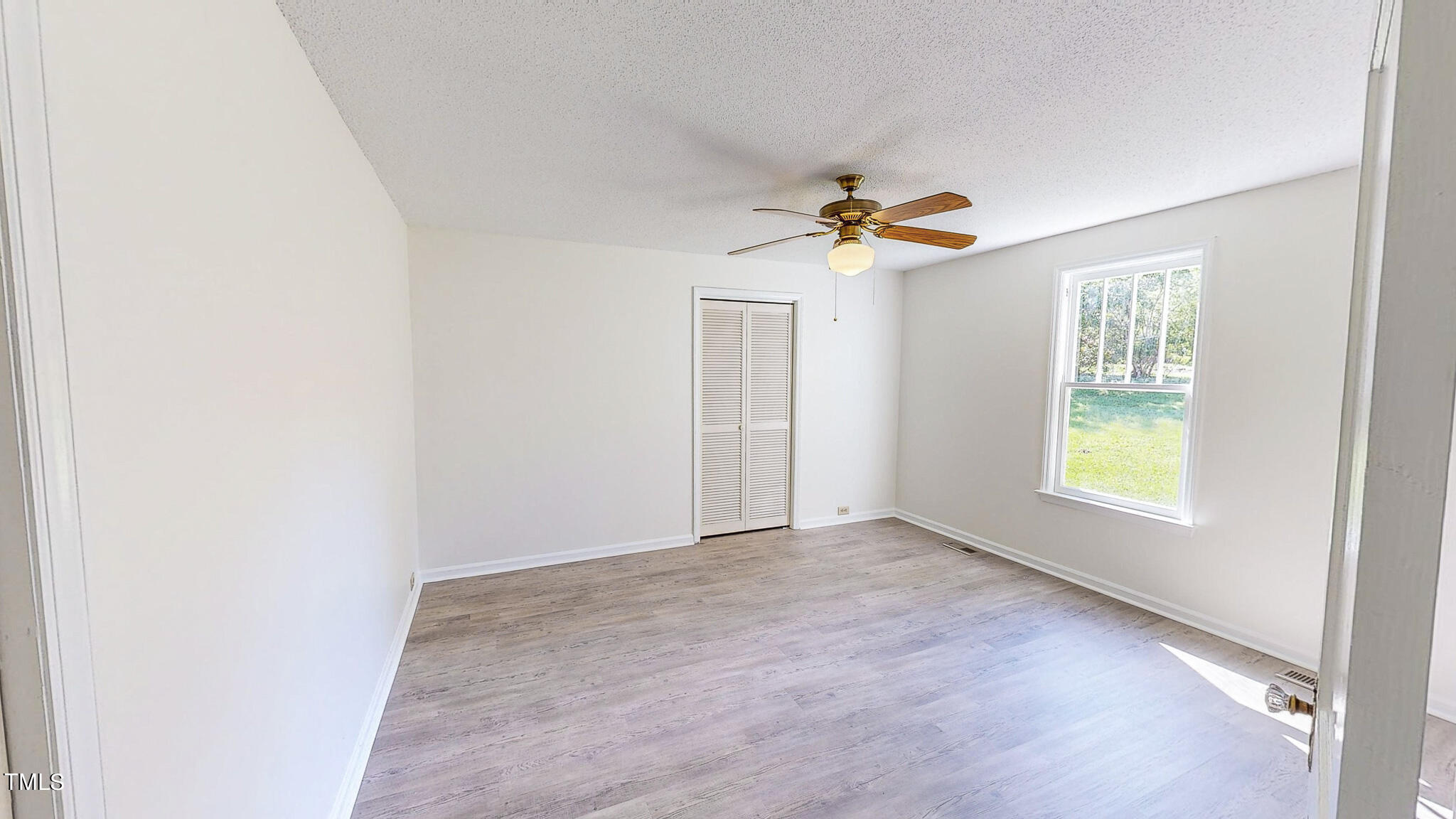 3906 Cole Mill Road Durham, NC 27712 - Photo 20 of 33 an empty room with windows and fan