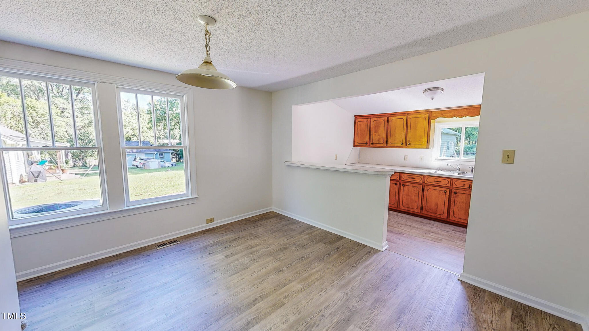 3906 Cole Mill Road Durham, NC 27712 - Photo 2 of 33 a view of a kitchen with wooden floor electronic appliances and windows