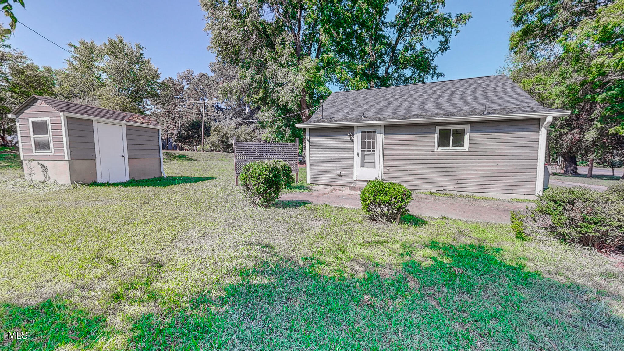 3906 Cole Mill Road Durham, NC 27712 - Photo 23 of 33 a view of a yard in front of a house with plants and large tree