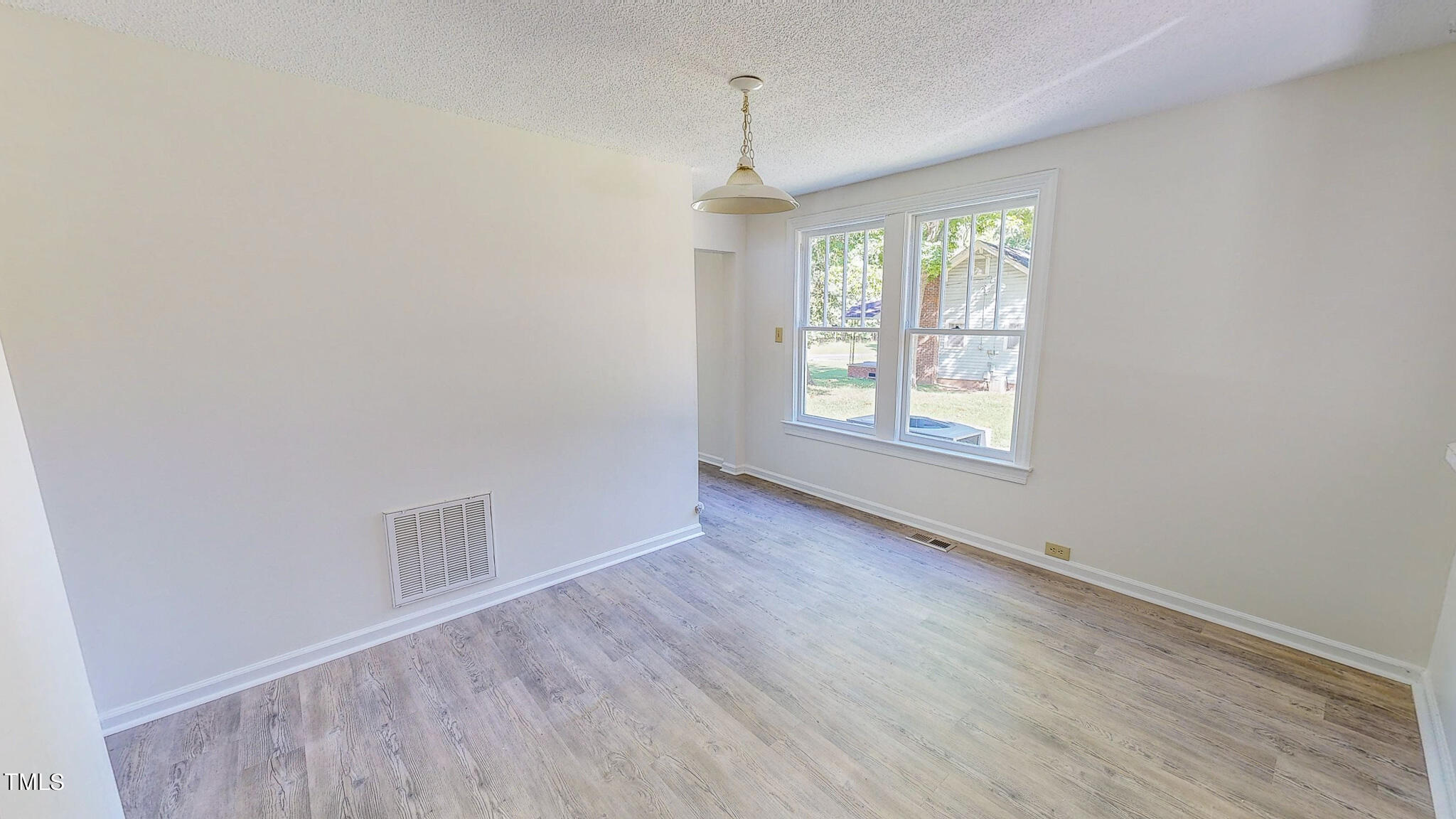 3906 Cole Mill Road Durham, NC 27712 - Photo 24 of 33 an empty room with wooden floor and windows