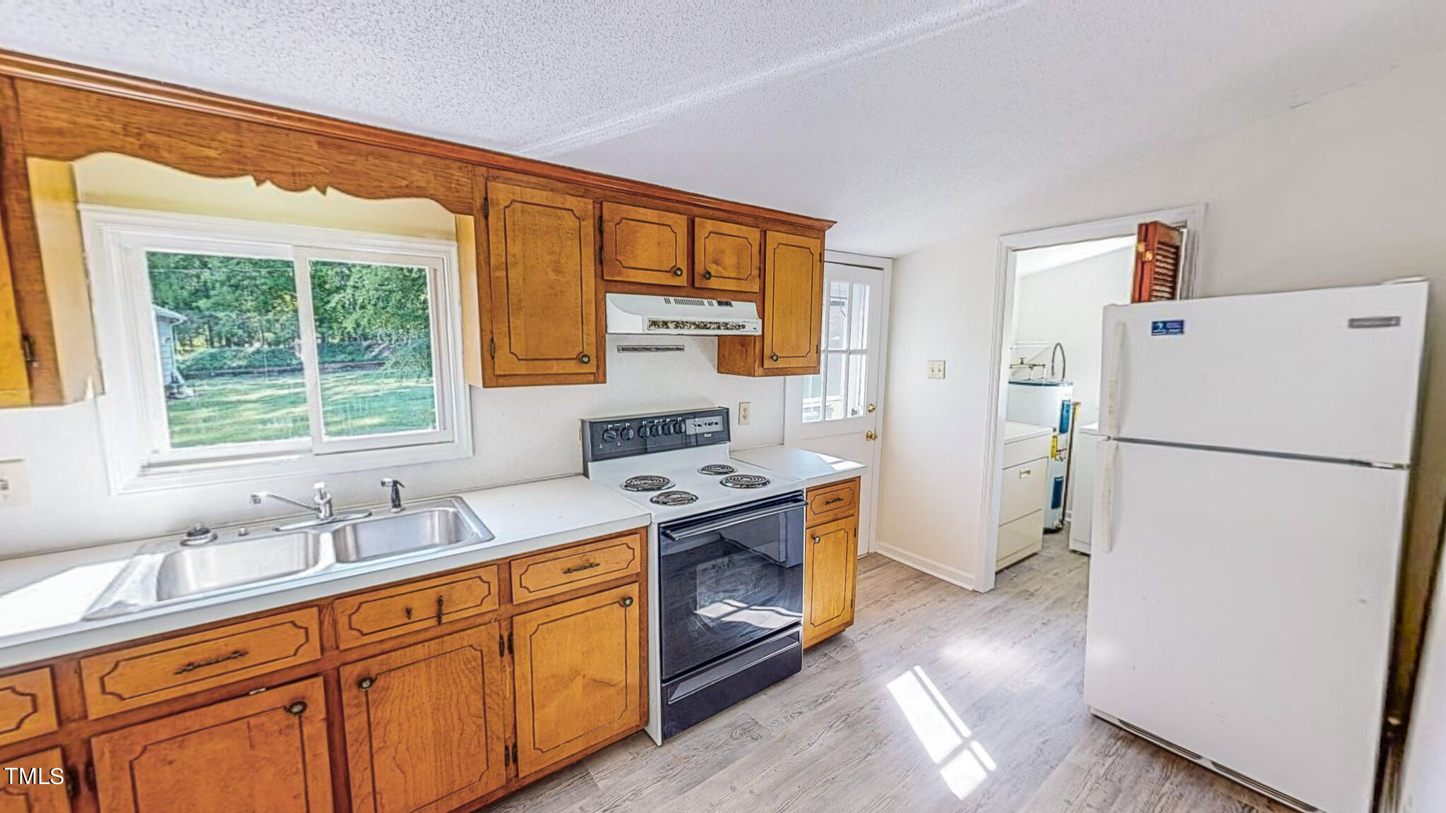 3906 Cole Mill Road Durham, NC 27712 - Photo 27 of 33 a kitchen with a refrigerator sink and cabinets