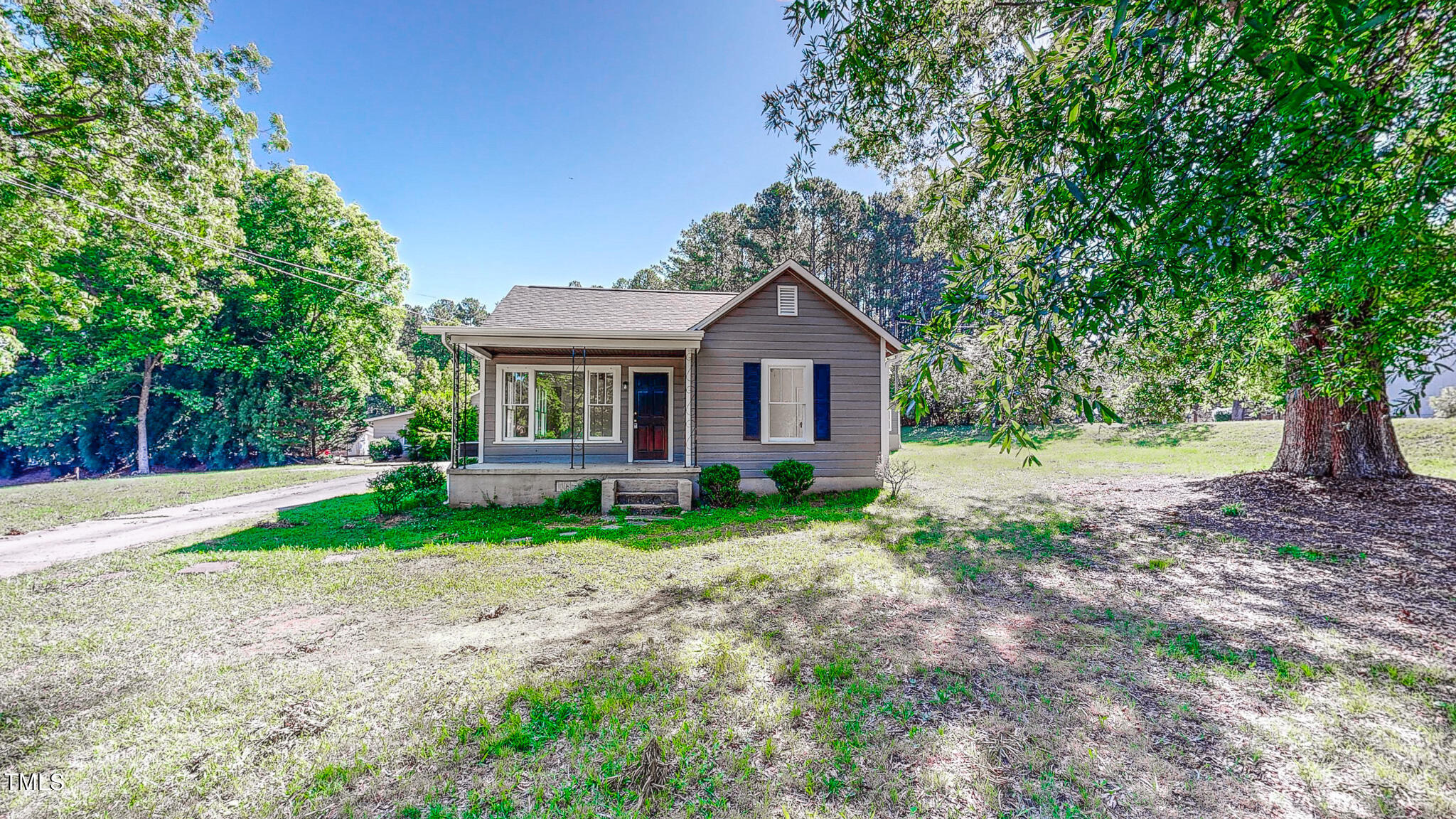 3906 Cole Mill Road Durham, NC 27712 - Photo 29 of 33 a view of a yard in front of a house with large trees