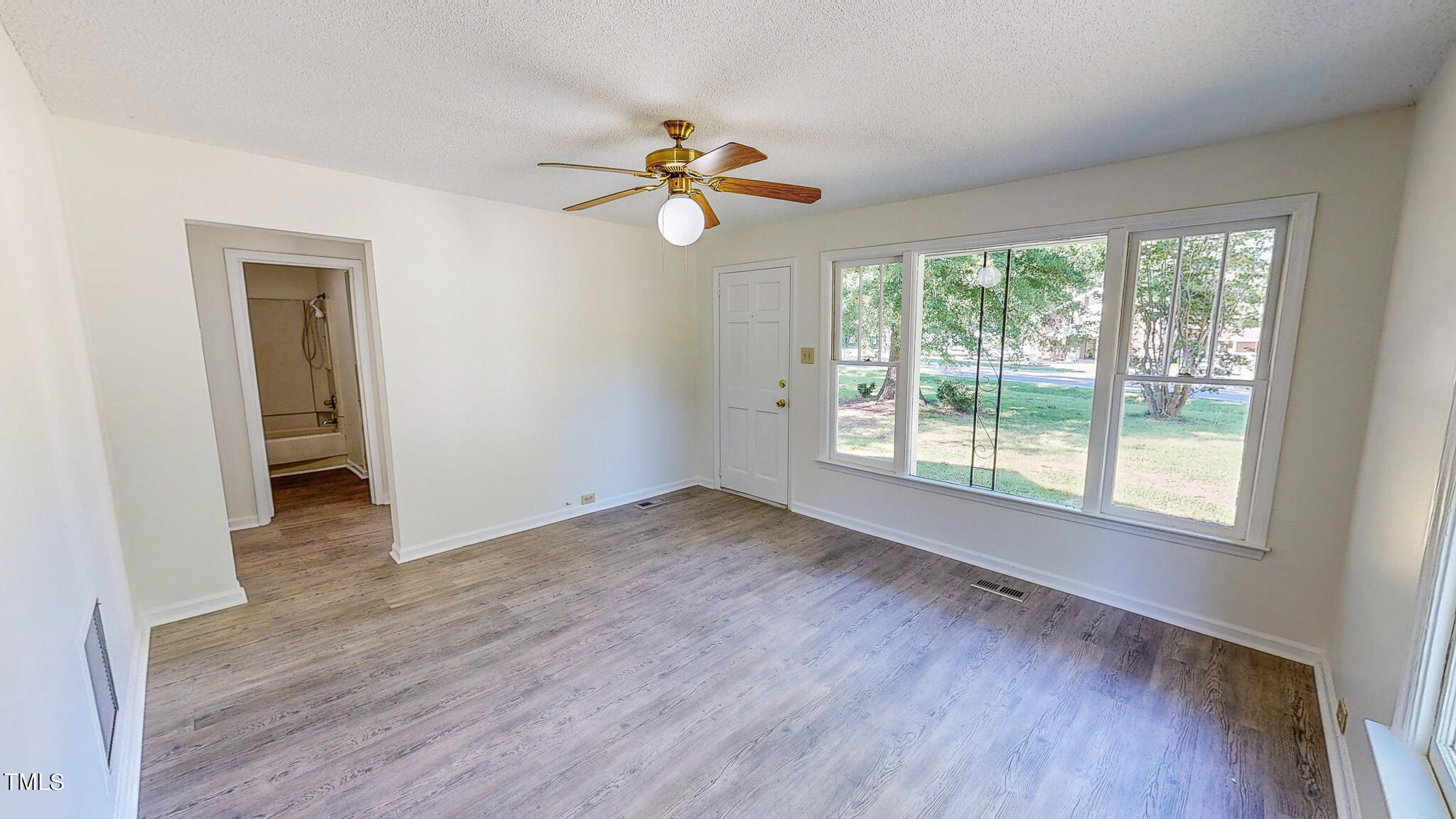 3906 Cole Mill Road Durham, NC 27712 - Photo 3 of 33 a view of empty room with wooden floor and fan