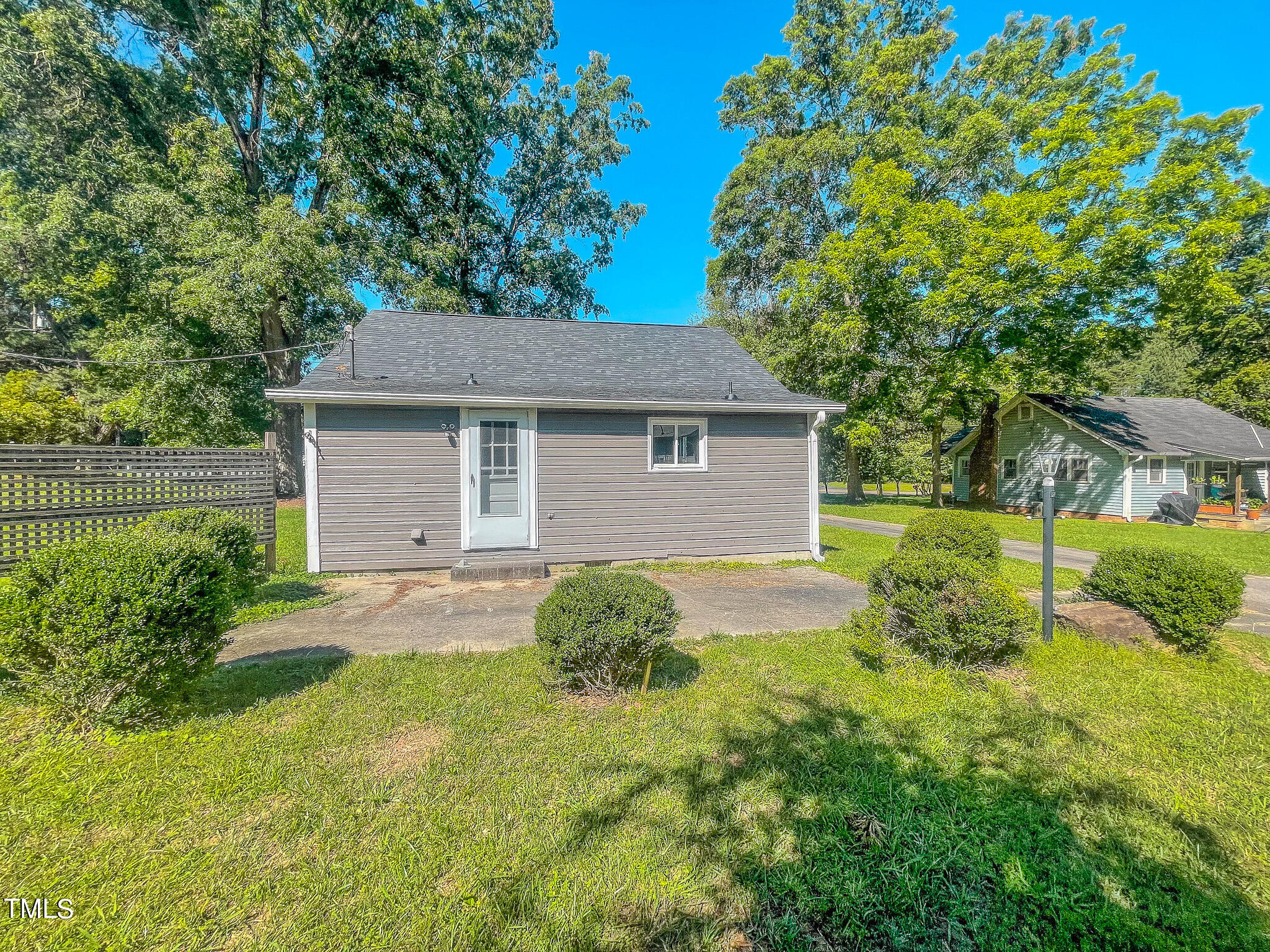 3906 Cole Mill Road Durham, NC 27712 - Photo 5 of 33 a backyard of a house with plants and large tree