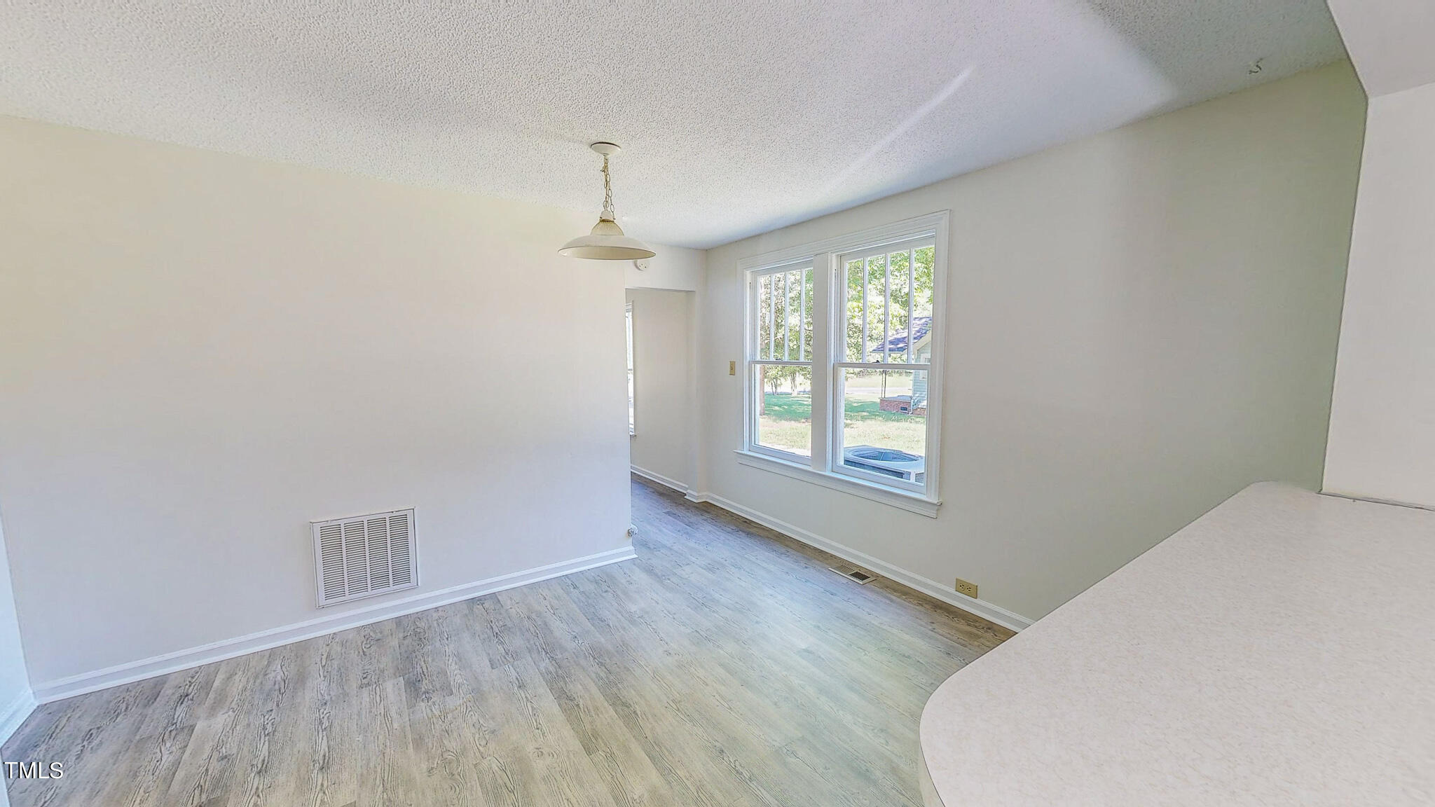 3906 Cole Mill Road Durham, NC 27712 - Photo 8 of 33 an empty room with wooden floor and windows