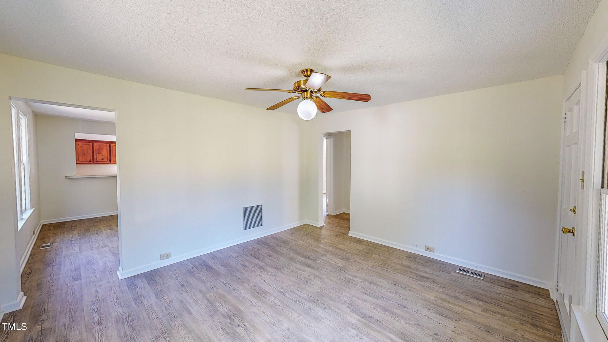 3906 Cole Mill Road Durham, NC 27712 - Photo 9 of 33 a view of empty room with wooden floor and fan