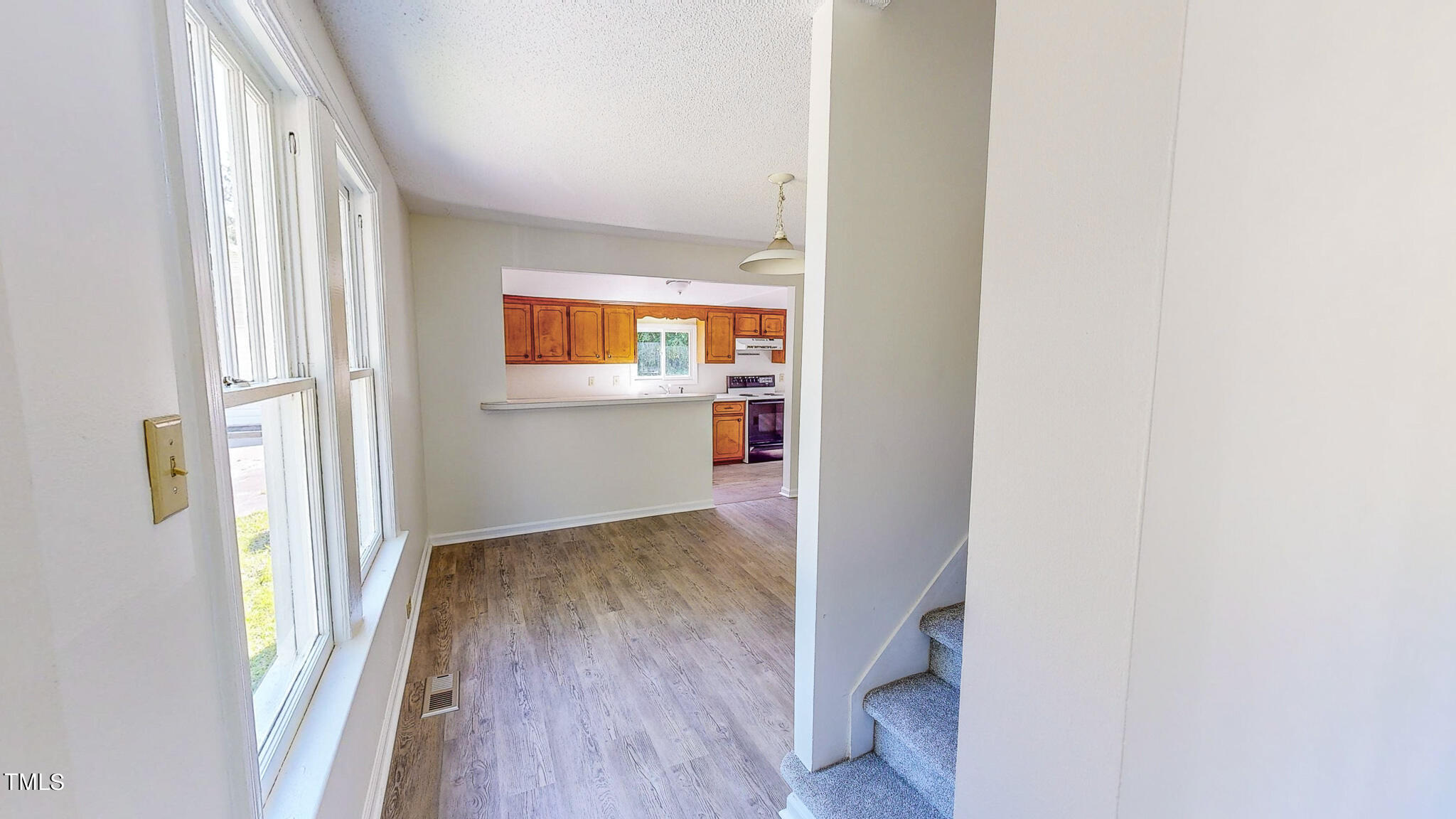 3906 Cole Mill Road Durham, NC 27712 - Photo 10 of 33 a view of a hallway with wooden floor and a bathroom