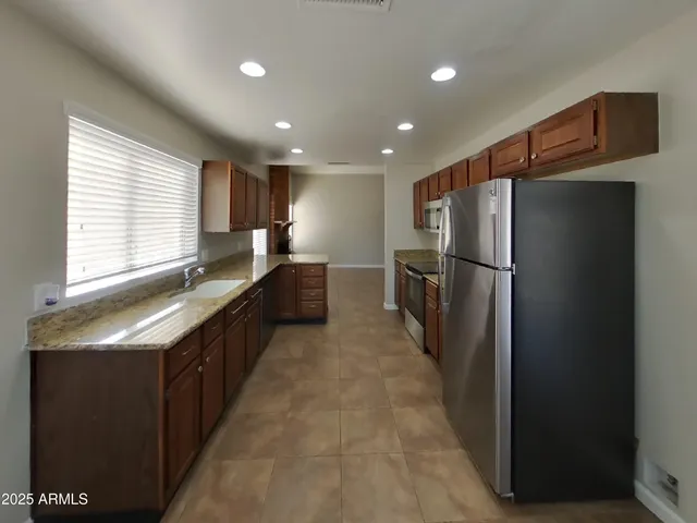 a kitchen with stainless steel appliances a stove sink and microwave