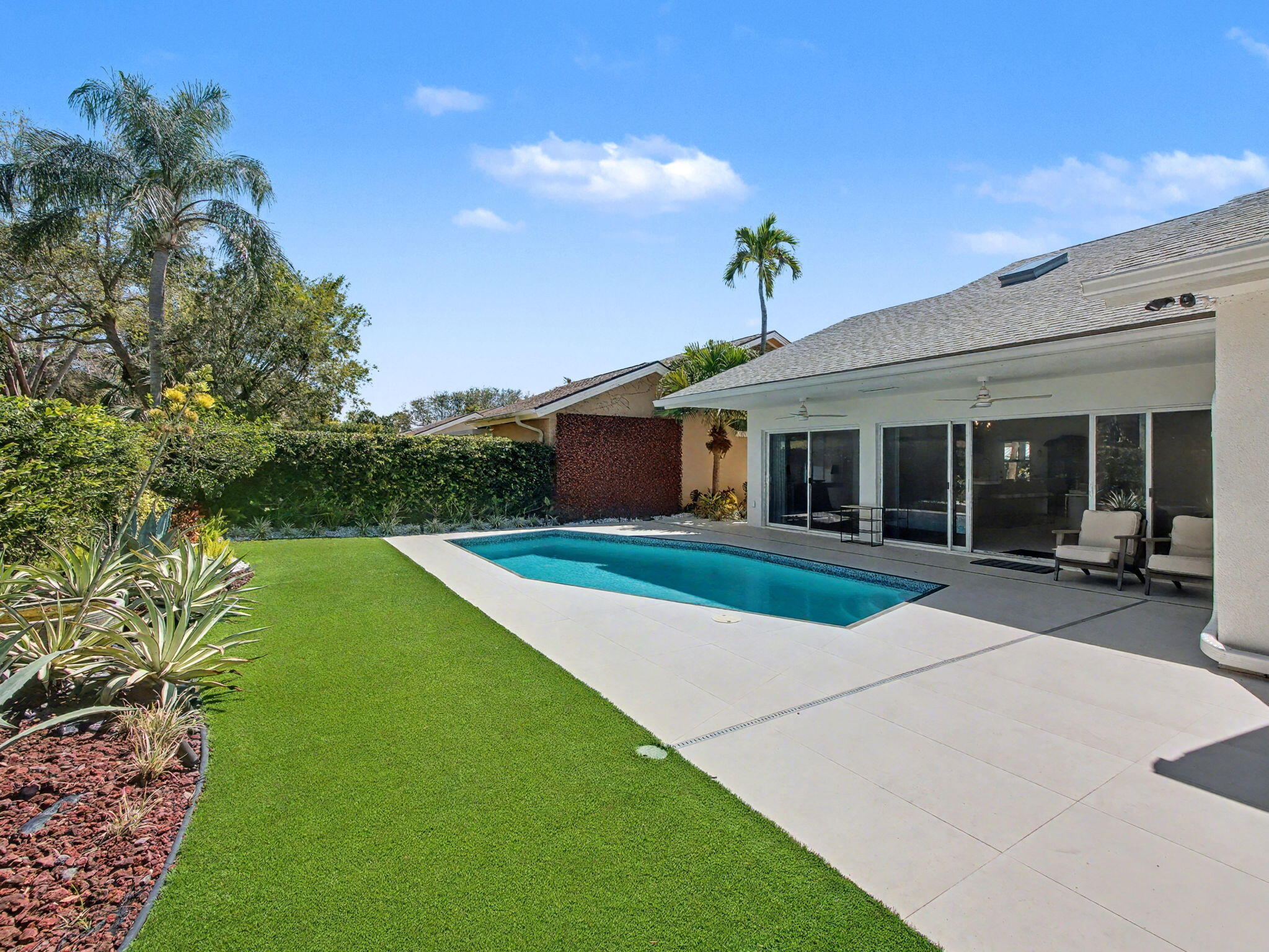 101 Dunes Edge Road Jupiter, FL 33477 - Photo 38 of 42 a front view of a house with a yard and potted plants