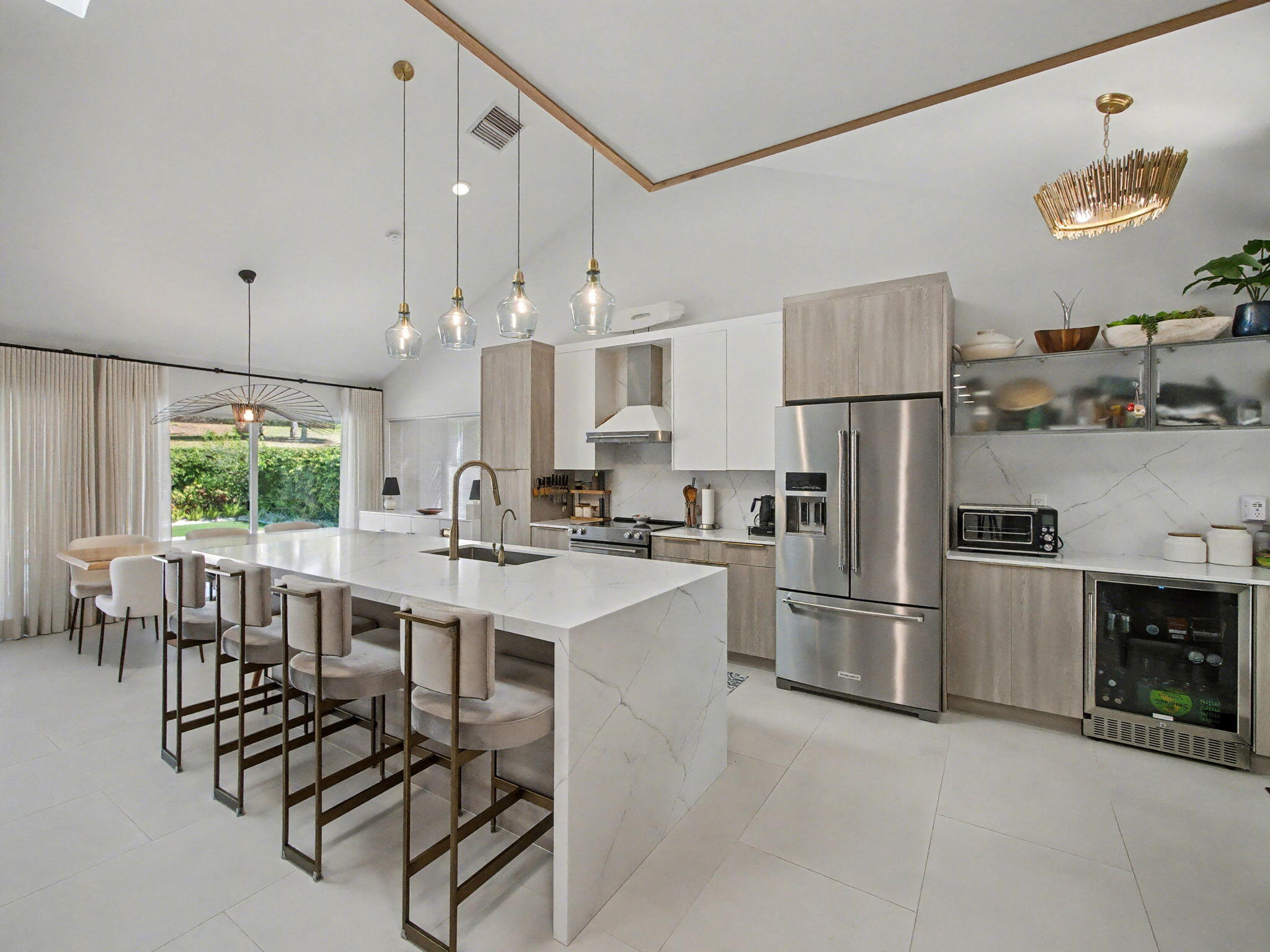 101 Dunes Edge Road Jupiter, FL 33477 - Photo 8 of 42 a kitchen with refrigerator and chairs