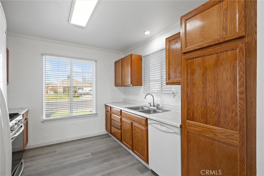 2067 Blossom Avenue Corning, CA 96021 - Photo 12 of 37 a kitchen with stainless steel appliances granite countertop a sink stove and refrigerator