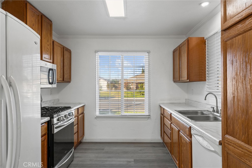 2067 Blossom Avenue Corning, CA 96021 - Photo 13 of 37 a kitchen with a sink cabinets stainless steel appliances and a window