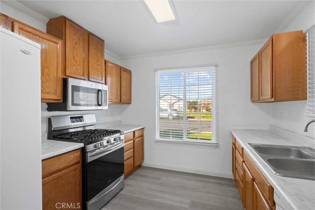 2067 Blossom Avenue Corning, CA 96021 - Photo 14 of 37 a kitchen with stainless steel appliances granite countertop a stove a sink and a microwave