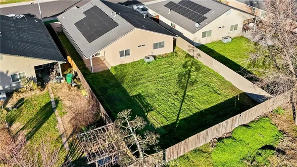 a view of a backyard with wooden fence
