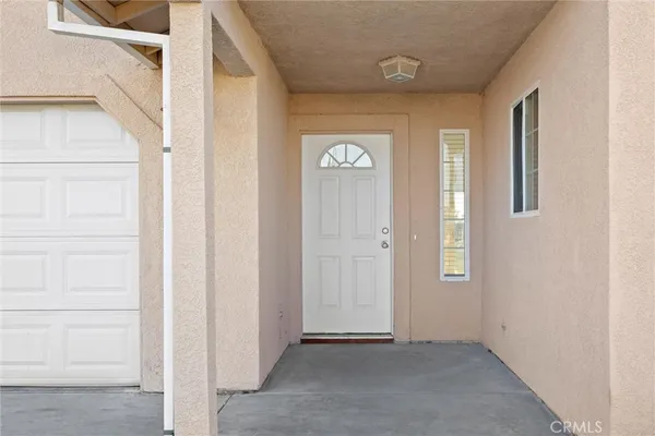 a view of an entryway with wooden floor