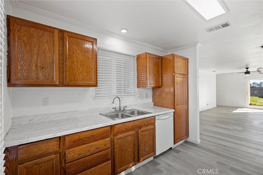 2067 Blossom Avenue Corning, CA 96021 - Photo 9 of 37 a kitchen with a sink a refrigerator and cabinets