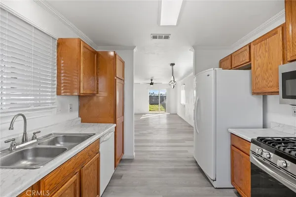 a kitchen with stainless steel appliances granite countertop a refrigerator and a sink