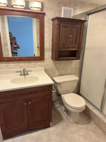a kitchen with a refrigerator sink and cabinets