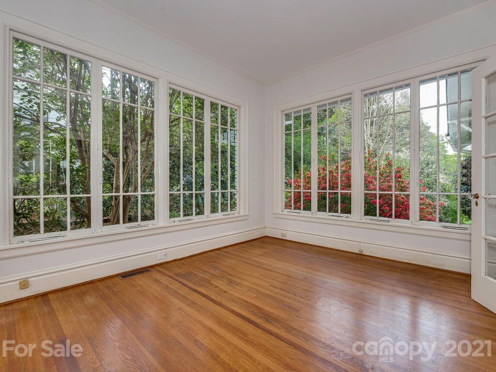 1600 Queens Road Charlotte, NC 28207 - Photo 11 of 30 a view of an empty room with wooden floor and a window