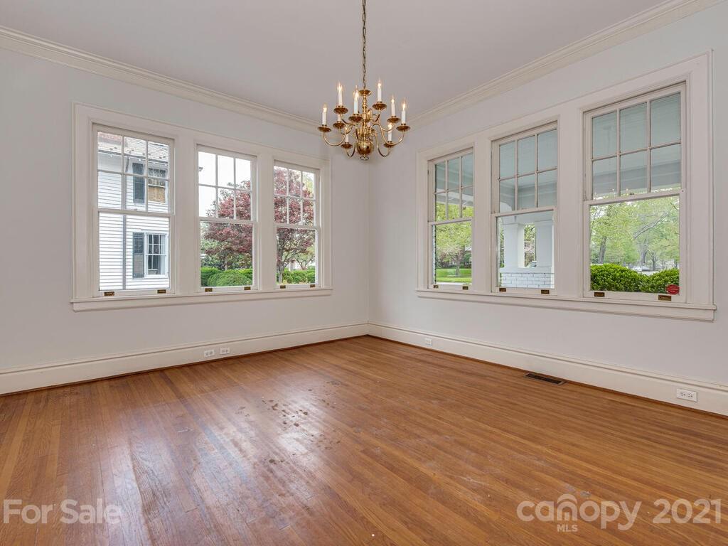 1600 Queens Road Charlotte, NC 28207 - Photo 12 of 30 a view of an empty room with wooden floor and a window