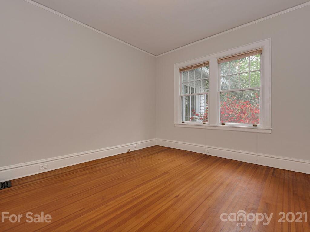 1600 Queens Road Charlotte, NC 28207 - Photo 16 of 30 a view of an empty room with wooden floor and a window
