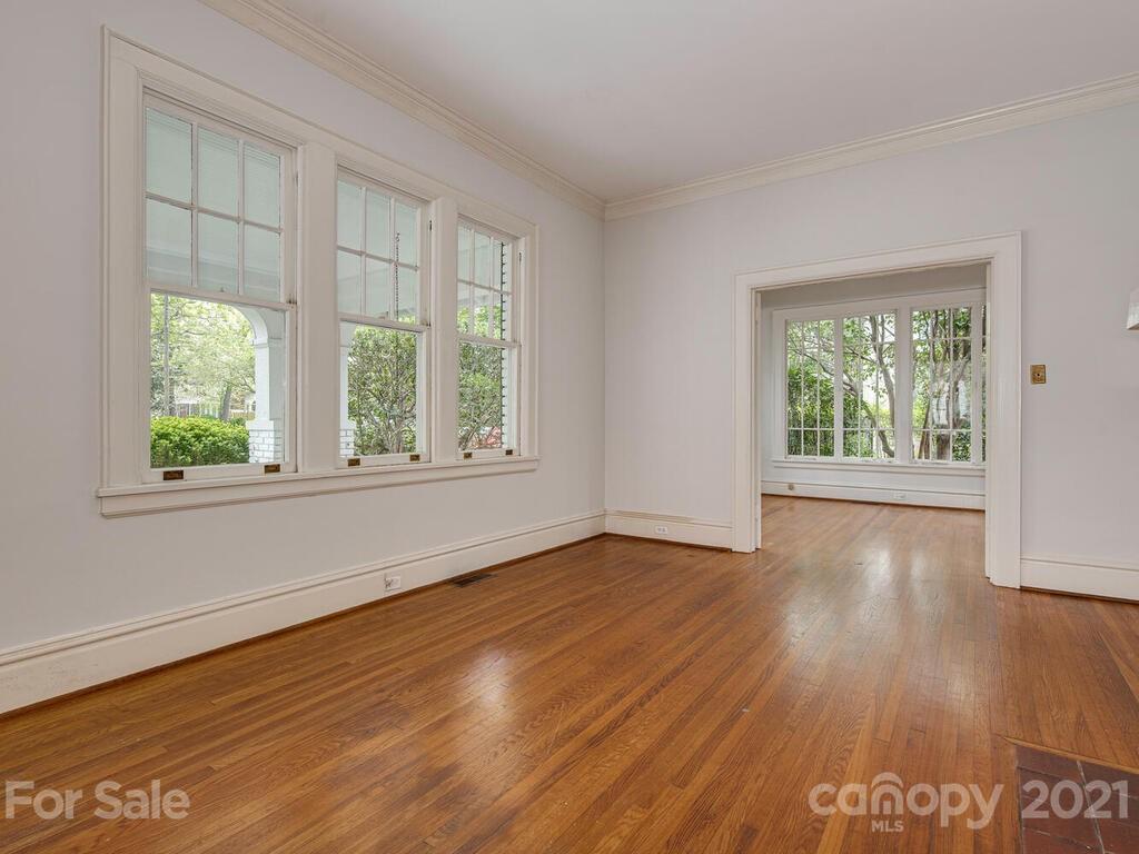 1600 Queens Road Charlotte, NC 28207 - Photo 7 of 30 an empty room with wooden floor and windows