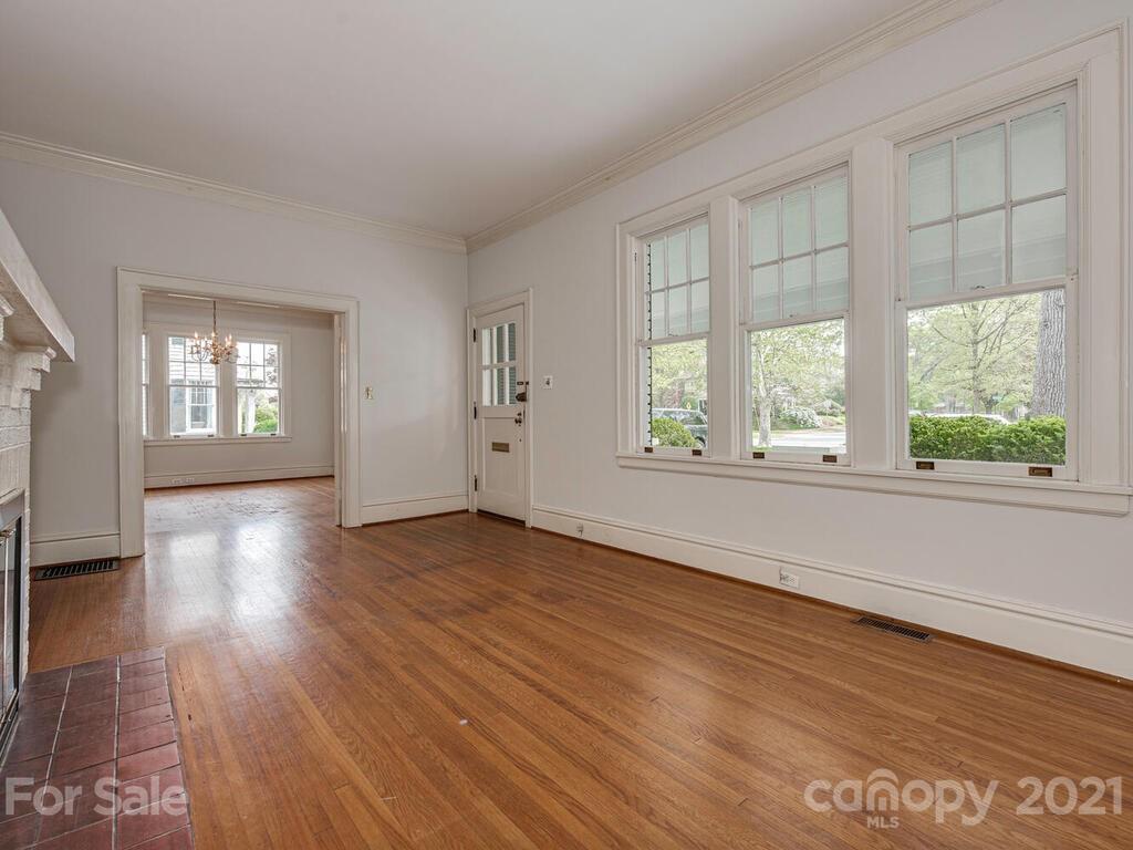 1600 Queens Road Charlotte, NC 28207 - Photo 9 of 30 a view of an empty room with wooden floor and a window