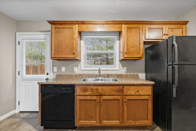 a kitchen with stainless steel appliances granite countertop a stove and a microwave