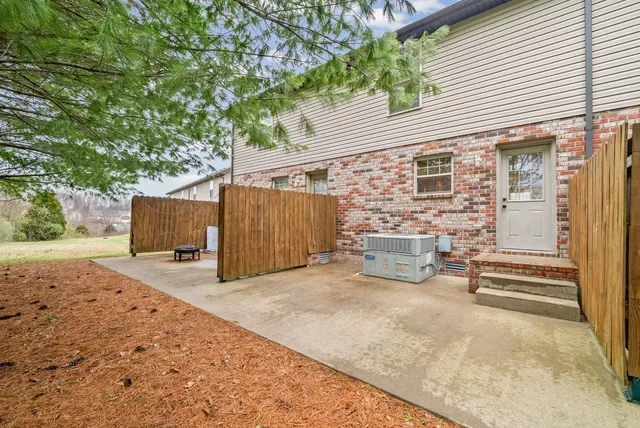 a backyard of a house with wooden fence