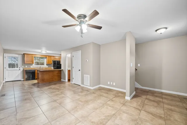 an empty room with windows and closet