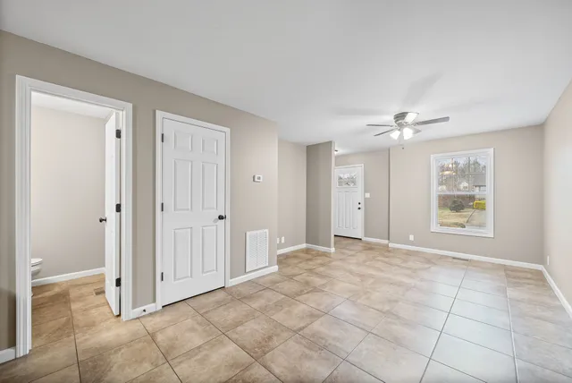 a bathroom with a granite countertop sink a toilet and a mirror
