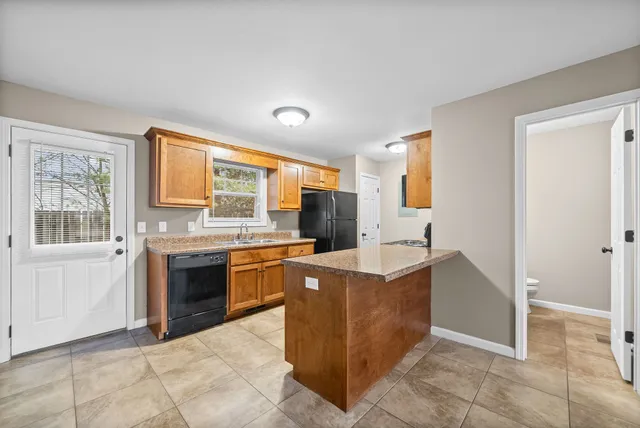 a kitchen with stainless steel appliances granite countertop a refrigerator and a stove top oven