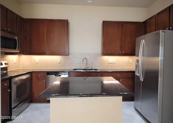 a kitchen with a sink and a refrigerator