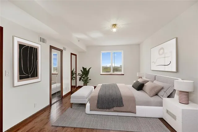 a bedroom with a large bed and a window