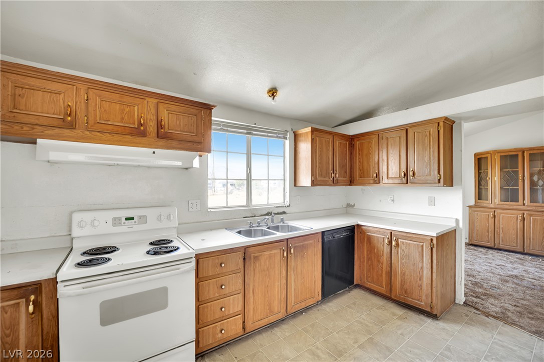 4361 Maple Road Pahrump, NV 89048 - Photo 12 of 46 Functional kitchen with ample cabinetry and a window offering natural illumination.