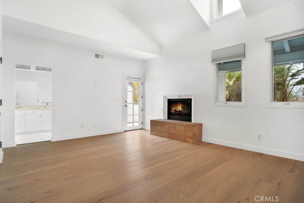 6435 Zumirez Drive, Unit 2 Malibu, CA 90265 - Photo 21 of 32 an empty room with windows and fireplace