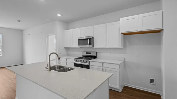 a kitchen with a sink a stove and cabinets