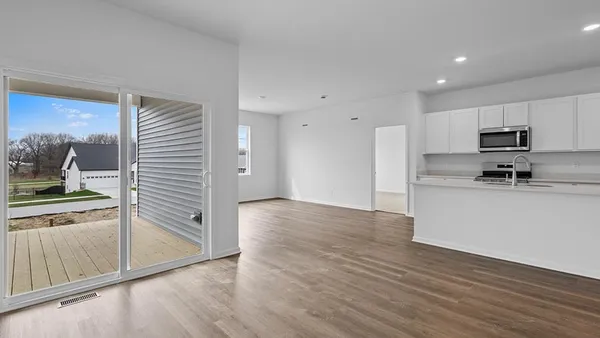 a view of kitchen with wooden floor and electronic appliances