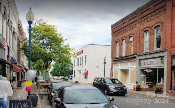 a couple of cars parked in front of a building
