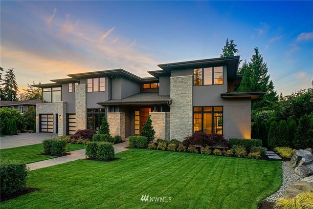 a front view of a house with a garden and plants