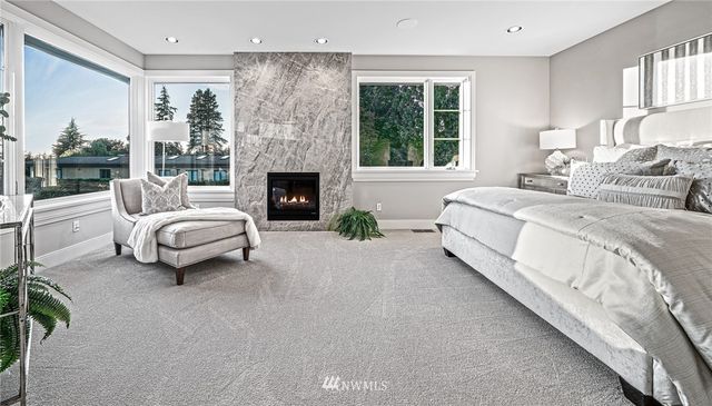 a spacious bedroom with a bed and large windows