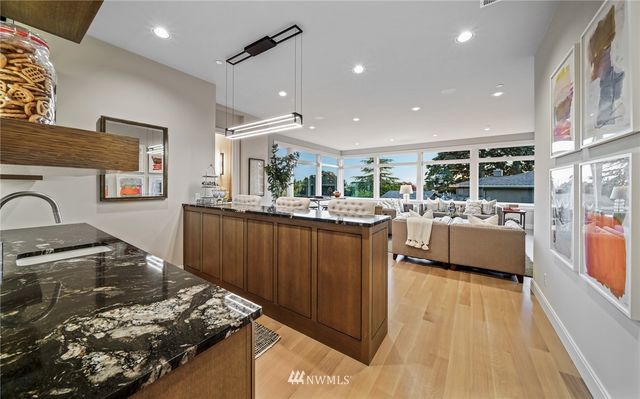 a kitchen with stainless steel appliances granite countertop a sink and a stove